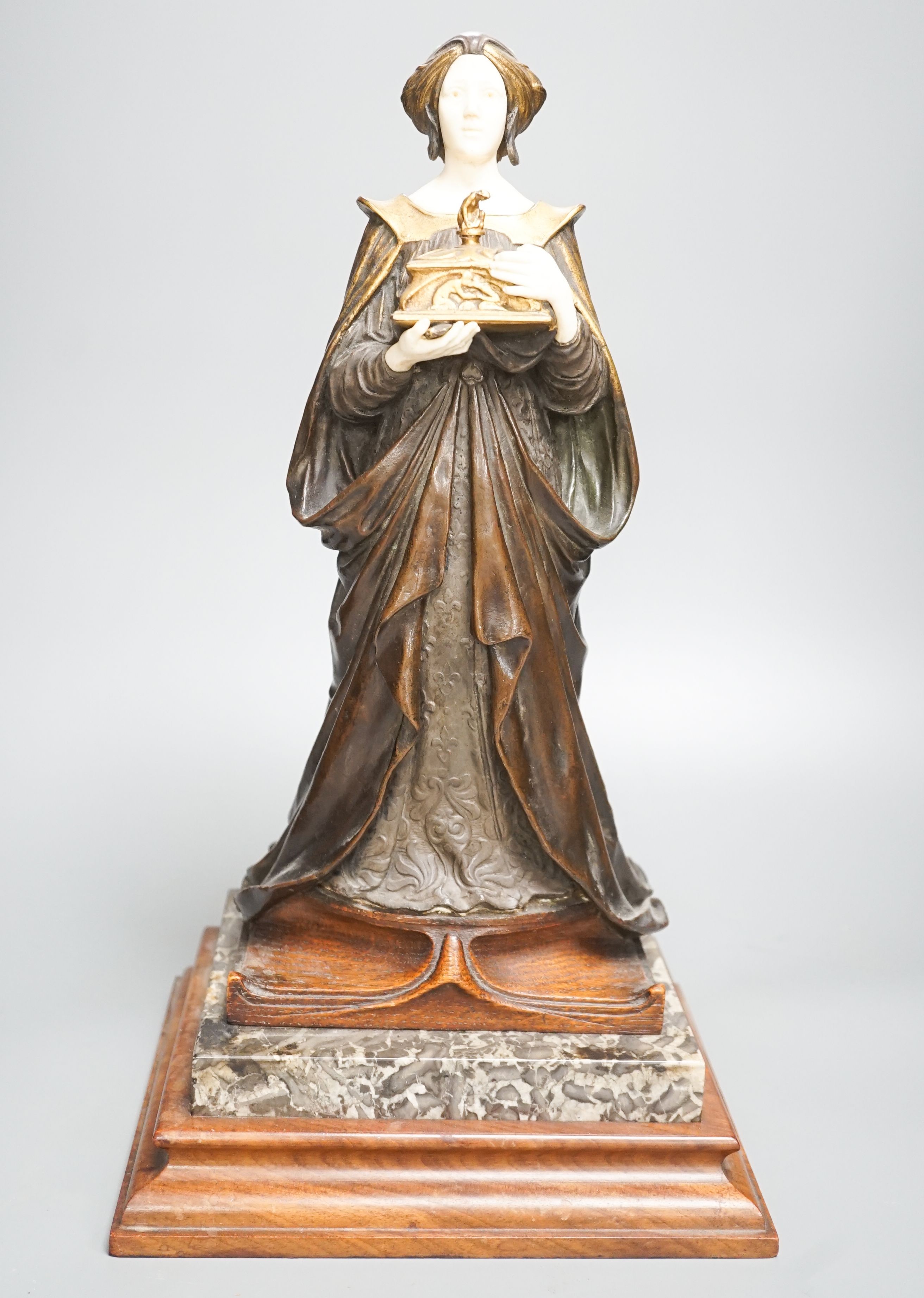 A German Art Nouveau bronze and ivory figure of Pandora, with inset carved ivory head and hands on polished stone and cut wood base, signed F. Jahn, 41cm high